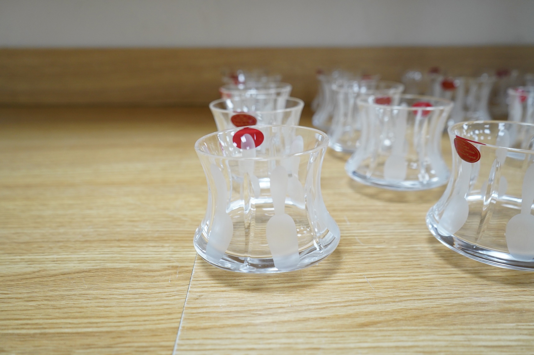 A collection of twenty five Uri Geller Crystal Collection whisky tumblers by Dickenson Crystal, 9cm high
